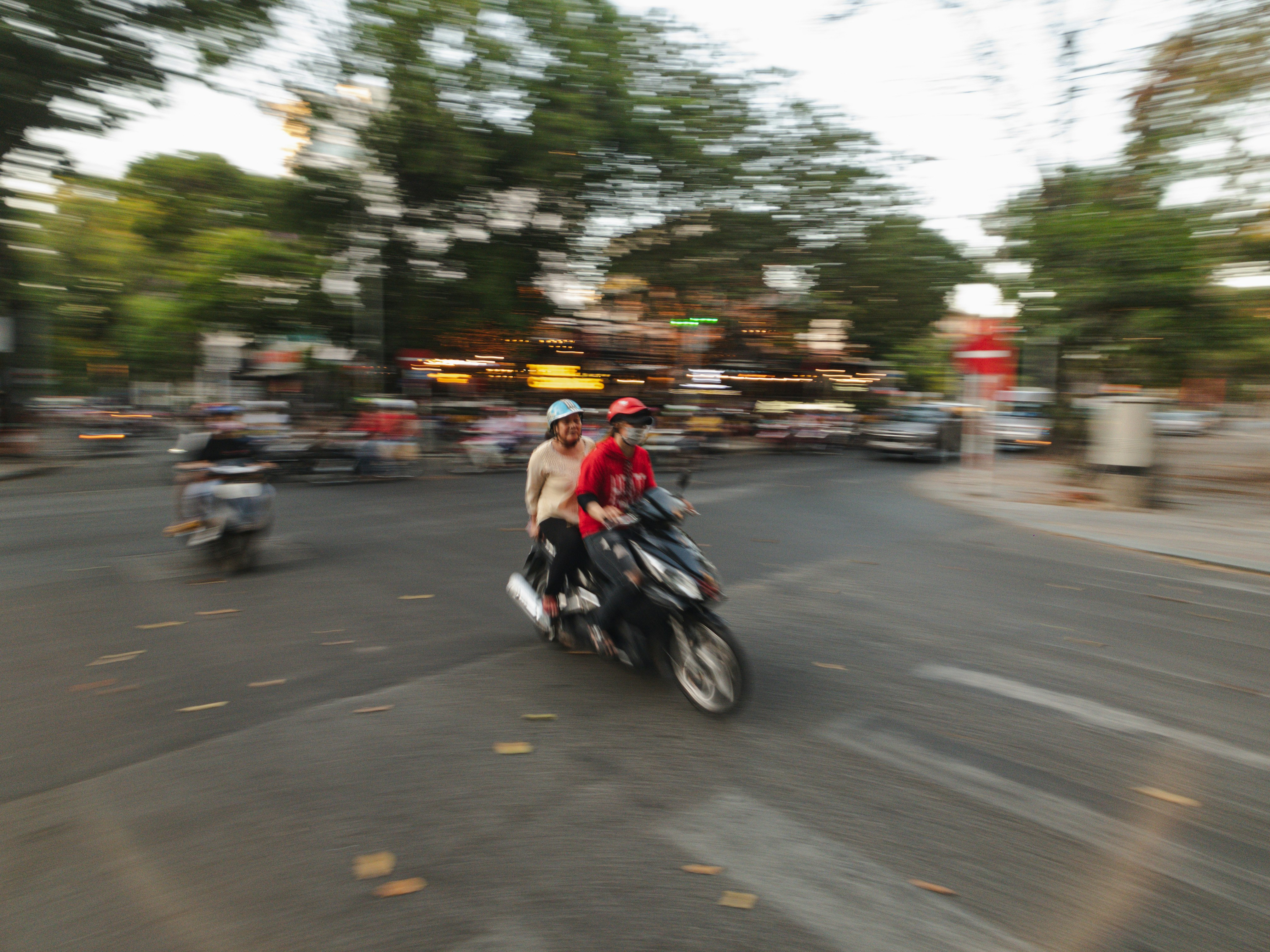 man in red jacket riding motorcycle on road during daytime